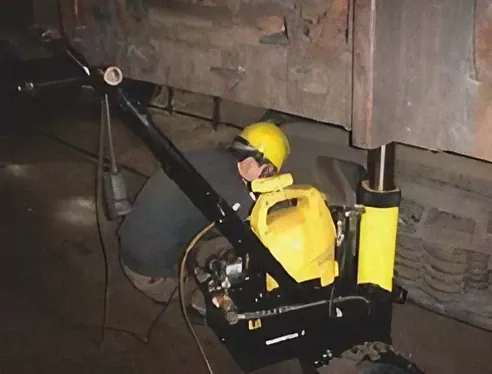 Hydraulic car racking machine lifting train cars.